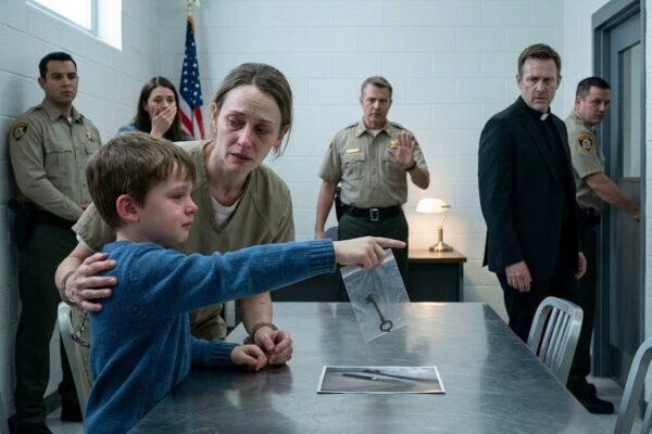 The first thing I remember about the execution room is the sound.  Not my mother crying. Not Matthew begging. Not even the guard telling us where to stand.  It was the buzz from the lights, thin and steady, hanging over us like the building itself did not care what it was about to do.  Image  My mother walked in with cuffs on her wrists and a tired smile on her face. She had been in prison for six years, and prison had taken almost everything soft from her. Her cheeks were hollow. Her hair had gray in it. Her eyes still searched for us the way they had when we were little, like she was counting heads at a grocery store and making sure none of her children had wandered off.  I was twenty-three by then, but the moment she saw me, I felt seventeen again.  That was how old I had been when my father died.  He had been found in our kitchen. The floor was clean in some places and dark in others. I did not see the worst of it because an officer stopped me in the hallway, but I saw enough to understand that a life could be divided into before and after by one open doorway.  The knife was found under my mother’s bed.  There was blood on her robe.  My Uncle Ray told the police he had gone looking because something felt wrong. He said he found the knife while trying to help. He said he called the police because family had to do the right thing, no matter how ugly the truth was.  People believed him.  I wanted not to believe him, but grief makes cowards out of people who do not know where to put their pain.  My mother kept saying she did not do it. She said she had gone to bed after an argument. She said she woke up to sirens and Ray’s voice in the hallway. She said the robe had been hanging on the bathroom door when she last saw it.  Every sentence sounded thin once the police said evidence.  Every tear looked like acting once the news called her a killer.  At the trial, I sat behind the prosecutor and listened to strangers talk about my family like we were a diagram on a board. They pointed at photos. They said motive. They said opportunity. They said domestic rage. They said the knife was found hidden where only she would have put it.  My mother turned once and looked at me.  I looked down.  That was the moment I lost her before the court ever sentenced her.  After the verdict, the house changed hands in ways I was too numb to question. Uncle Ray said I was too young to manage bills, lawyers, reporters, and Matthew. He said my father would have wanted him to help. He started staying over. Then he started staying for good. He sorted boxes, signed repair papers, changed locks, and told everyone he was keeping the family together.  I should have noticed how comfortable he became.  Instead, I watched Matthew.  He was two when Dad died, too young to explain what he had seen and too small to be asked the right questions. For years, he had nightmares without words. He would wake up shaking and crawl into the hallway, but when I asked what scared him, he would press both hands over his mouth.  Ray always said, “Kids absorb panic. Don’t put ideas in his head.”  So I stopped asking.  My mother wrote from prison every month.  Sometimes the letters were long. Sometimes they were only a few lines. She asked whether Matthew still liked pancakes. She asked if I was eating enough. She asked whether Dad’s old garden chair was still on the porch.  At the bottom of almost every letter, she wrote the same thing.  I didn’t kill him, sweetheart.  I kept every page in a shoebox under my bed. I told myself that keeping them meant I still loved her, but love without courage is a quiet kind of betrayal. I rarely answered. I did not know how to write to a mother I had failed.  The execution date came in a plain envelope.  I remember sitting on the edge of the bathtub with the letter in my hand while Matthew stood in the doorway, nine years old then, too still for a child. He did not ask what it meant. Somehow he already knew.  In the weeks before it happened, Ray became helpful in a way that made people praise him. He brought casseroles. He answered calls. He told church ladies that forgiveness was complicated. He said my mother had made choices that none of us could fix.  The day before the execution, he came to the house wearing a dark coat and asked if Matthew wanted to say goodbye.  Matthew said yes so quickly that Ray stared at him.  That night, my brother knocked on my bedroom door. He was wearing the blue sweater Mom had mailed him one Christmas from prison. It was too small in the sleeves, but he would not let me donate it.  He asked if Dad could still see us.  I told him I hoped so.  Then he asked, “If I tell the truth, will Uncle Ray hurt you?”  The question came out so softly that I almost convinced myself I had misheard it.  I sat up.  “What truth?”  Matthew began to cry, but no sound came out. His whole face twisted like a child trying to hold back a storm with his teeth. I moved toward him, and he backed into the hall.  “Tomorrow,” he whispered. “I have to tell Mom first.”  I did not sleep after that.  By morning, the sky looked washed out and colorless. Ray drove behind us to the prison because he said family should arrive together. He kept looking at Matthew in the rearview mirror at red lights. Matthew kept one hand in his pocket the whole drive.  The goodbye room was smaller than I expected.  There was a table, several chairs, a clock, and a wall that had been painted a beige color meant to calm people who could not be calmed. A small flag stood near the warden’s desk. Two guards watched the door.  My mother came in slowly.  When she saw Matthew, she stopped.  “Baby,” she breathed.  The guard started to explain the rules, but the warden saw Matthew’s face and let the words die.  Mom bent down as far as the cuffs allowed. She told Matthew she was sorry for all the birthdays, the school mornings, the loose teeth, the scraped knees, and the ordinary days she had missed. She did not say she was sorry for killing Dad because she had never stopped refusing that lie.  Matthew hugged her.  At first, it looked like a goodbye.  Then his lips moved next to her ear.  “Mom… I know who hid the knife under your bed.”  My mother’s body changed before the words reached the rest of us. Her shoulders locked. Her chin lifted. She was still holding Matthew, but her eyes went straight to mine.  The guard stepped forward.  “What did you say, kid?”  Matthew turned, pale and shaking.  “I saw him. That night, it wasn’t my mom.”  The room became so silent that the clock sounded rude.  The warden lifted his hand.  “Stop everything.”  Nobody had prepared for those words. Not the guards. Not me. Not my mother.  And especially not Uncle Ray.  He had been standing near the back wall in the posture of a grieving relative who had learned how to look holy in public. His hands were folded. His face was solemn. He had even brought a tissue, as if he planned to perform sadness one last time.  When Matthew looked at him, Ray’s hand closed around that tissue until it disappeared.  “It was him,” Matthew said, pointing. “And he told me that if I talked, he was going to bury my sister too.”  My mother screamed my name so sharply that one guard reached for her arm.  Ray tried to smile.  “That child is confused,” he said. “He was two. He doesn’t know what he saw.”  But Matthew was not finished.  He pulled a small plastic bag from his pocket. Inside was an old key with a strip of masking tape wrapped around the top. I recognized the handwriting on the tape before anyone asked.  It was my father’s.  Matthew said Dad had given it to him during a game of hide-and-seek a few nights before he died. Dad told him it was a secret key and that if Mom was ever in terrible trouble, especially if someone said she was going to die, Matthew had to use it on the hidden drawer in the wardrobe.  He had been too little to understand.  Then Ray started warning him.  Every year, every time Matthew almost said something, Ray reminded him that sisters could disappear too. He made the threat sound like a bedtime warning. Quiet. Familiar. Permanent.  The warden took the key.  Ray said, “You have no right.”  The warden looked at the guards. “Nobody leaves.”  That was when I remembered everything I had filed away because it hurt too much to examine.  Ray had found the knife.  Ray had called the police.  Ray had moved through our house with keys before the funeral was even over.  Ray had told me to stop upsetting Matthew whenever my brother woke up crying.  Ray had kept my father’s wardrobe locked after saying the wood was warped.  The call to the house was placed from the warden’s desk. An officer on the other end was told exactly where to look. Back panel. Left side. Behind the hanging winter coats.  We waited while my mother stood cuffed beside the table.  Nobody spoke.  Ray breathed through his nose like an animal trying not to run.  Then the phone crackled.  They had found the drawer.  They had opened it.  Inside was a photo, a folded note, and a thin cloth bundle.  The warden asked what was in the bundle.  The officer said there was a glove, a piece of my mother’s robe, and a second small knife wrapped together. The robe piece had been cut from the inside hem, a place nobody at trial had ever mentioned. The note was in my father’s handwriting, short and shaking.  If anything happens to me, Ray planted it. He has access to the house. He knows where she sleeps.  My mother made a sound I will never forget.  It was not relief. It was not grief. It was the sound of a person reaching the surface after being held underwater for years.  Then the officer described the photo.  My father was standing outside the house beside Uncle Ray. Ray’s face was turned partly toward the camera. In my father’s hand was a folder. On the back of the photo, Dad had written that he was going to report Ray that night for threatening him and trying to take control of the house.  The man my father had gone to report was not a stranger.  He was standing in the goodbye room with us.  Ray lunged toward the table.  A guard caught him before he reached the phone.  For the first time in six years, my uncle stopped pretending to be calm. He cursed at Matthew. He called my father a liar. He said my mother had ruined everything by making people feel sorry for her.  That was when the warden nodded to the second guard.  Ray was taken out through the same door my mother had entered.  He looked at me once as they pulled him past, and I understood something terrible. He was not sorry my father was dead. He was sorry a child had remembered.  The execution did not happen that day.  Those words are simple, but they still feel too small for what they mean. My mother was minutes from being erased by a lie, and my little brother’s whisper pulled the world back from the edge.  There were hearings after that. There were statements, reports, signatures, and rooms where officials spoke in careful voices. I learned that truth can be obvious and still move slowly when the wrong people have spent years burying it.  Matthew had to tell his story more than once.  Each time, he shook. Each time, he looked for my mother before he answered. And each time, he said the same thing. He saw Ray come out of her bedroom. He saw something wrapped in a towel. He heard Ray tell him that good boys kept quiet if they wanted their sisters safe.  My mother listened to him with both hands pressed flat on the table.  She never interrupted.  When they finally let me sit alone with her, I could not say the speech I had practiced. I had imagined apologizing in a way that sounded grown and complete. Instead, I cried like I was seventeen again.  “I believed them,” I said.  She reached across the table. This time there were no cuffs between us.  “You were a child,” she said.  “I was old enough.”  “You were hurting.”  “I left you alone.”  Her fingers closed around mine.  “You came back.”  That was my mother. After six years of letters I barely answered, after six years of hearing her own daughter doubt her, she still chose the sentence that let me breathe.  Matthew took longer to forgive himself.  Children believe threats in their bones. He had carried Ray’s warning like a stone in his chest for most of his life. For months after the execution was stopped, he slept with the light on. He asked whether Ray could get out. He asked whether Mom would vanish if he said the wrong thing.  Mom told him the same answer every time.  “You saved me because you were brave when it mattered. The rest belongs to the adults who failed you.”  The house did not feel like ours at first.  Every room had a shadow in it. The kitchen was the hardest. Mom stood in the doorway the first day she came back and held the counter until her knuckles turned white. I thought she might leave.  Instead, she opened a window.  Cold air moved through the room. A neighbor’s dog barked. Somewhere down the street, a lawn mower started. Ordinary life pushed its way in without asking permission.  Mom looked at the floor for a long time.  Then she said, “Your father hated when people left dishes in the sink.”  Matthew laughed before he cried.  That sound broke something open in all of us.  We did not become happy all at once. Stories like ours do not end with one courtroom door or one signed order. My mother still woke from dreams where guards were calling her name. I still found old letters and had to sit down. Matthew still flinched when men raised their voices.  But Ray no longer owned the story.  For six years, he had survived because everyone looked at the wrong woman. He had counted on grief, shame, fear, and my silence. He had counted on a child being too small to matter.  He forgot that children grow.  The shoebox of my mother’s letters is still under my bed, but now it is full of answers too. I wrote back to every one I could bear to read. Some letters were apologies. Some were memories. Some were only one line long.  I believe you.  The last time I visited my father’s grave with Mom and Matthew, my brother brought the blue sweater. It did not fit him anymore. The sleeves stopped above his wrists, and the hem barely reached his waist.  He folded it and placed it on the grass.  Mom asked if he was sure.  Matthew nodded.  “I don’t need it to remember her,” he said, then looked at Mom and corrected himself. “I mean, to remember when I thought I was saying goodbye.”  My mother put one arm around him and one around me.  For a while, none of us spoke.  The world kept moving around us. Cars passed beyond the cemetery fence. A flag snapped softly near the road. Somewhere, someone laughed at a joke we could not hear.  I used to think justice meant the truth arrived loud, with sirens and certainty and everyone apologizing at once.  It did not happen that way.  In our family, justice arrived as a shaking little boy in a blue sweater, a hidden key in a plastic bag, and a mother who heard one whispered sentence minutes before the end.  The sentence was small.  It saved her life.